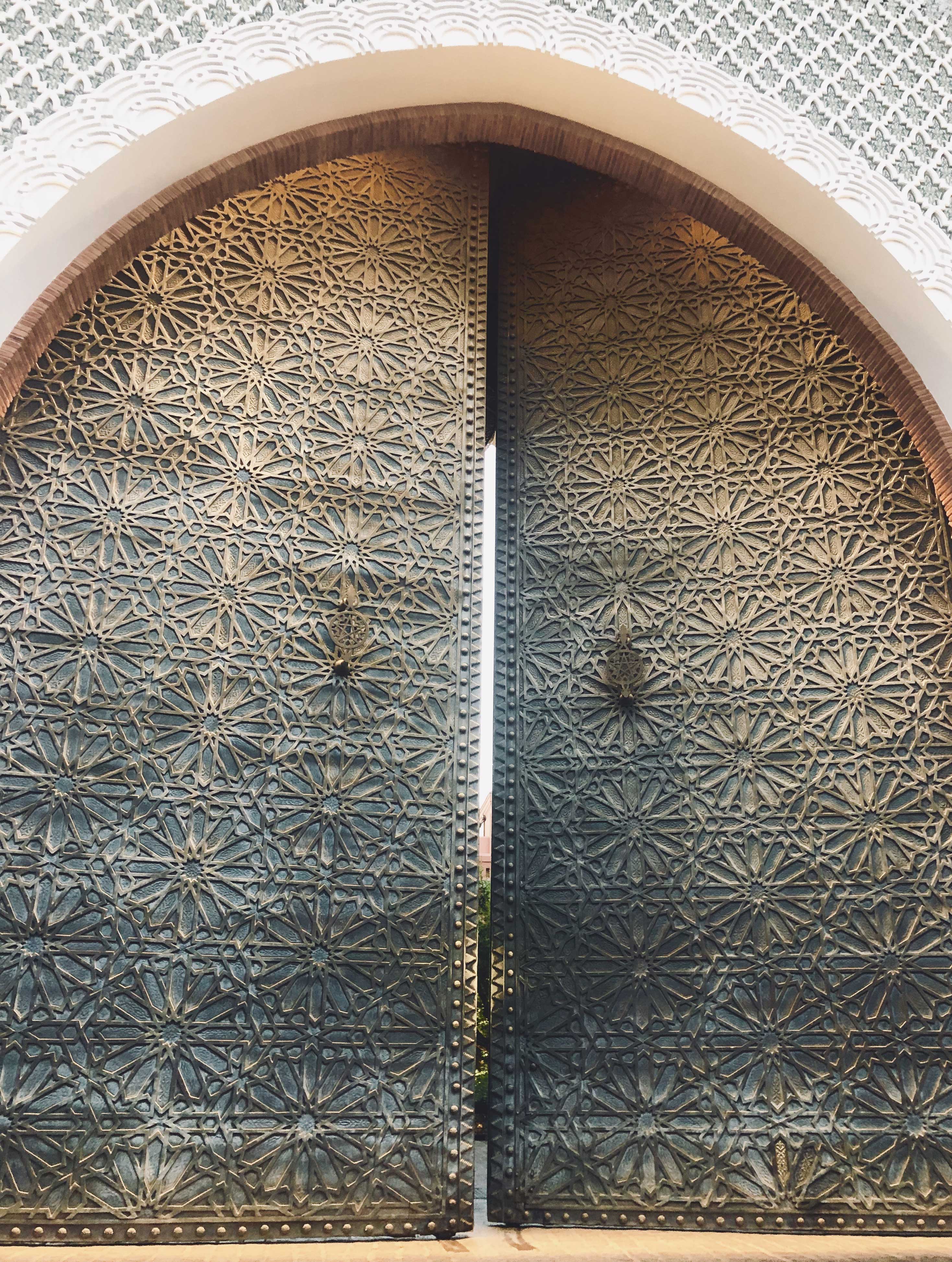 Arched brass door with hand-cut geometric star pattern, Marrakech